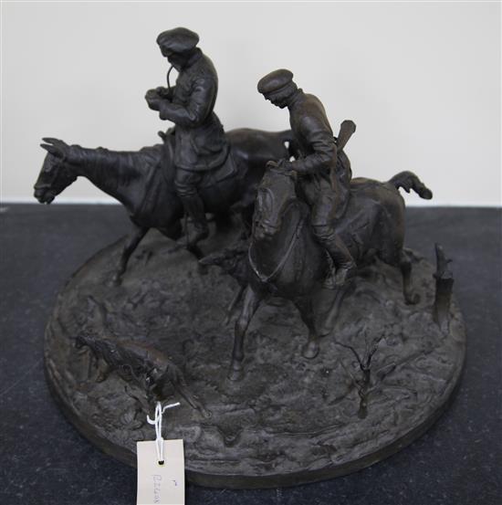 A 19th century Russian cast iron group of two huntsmen and five hounds, width 15in. height 11in.